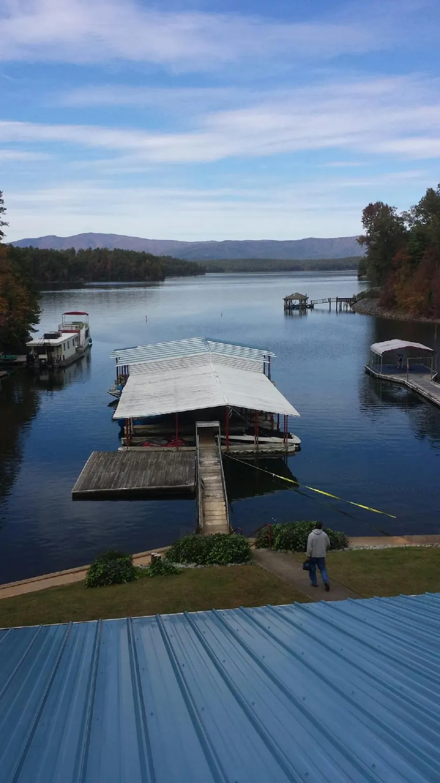 View across a lake from a newly installed blue metal roof in Bowling Green